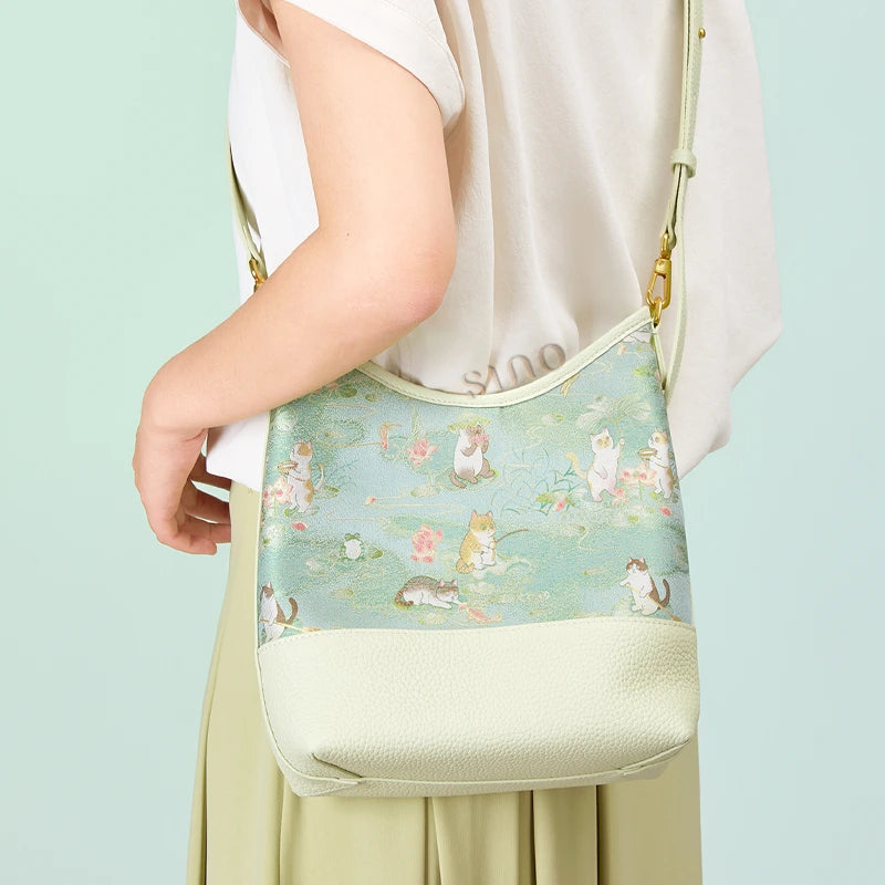 Model wearing the Springtime Tales Song Brocade leather shoulder bag with an adjustable strap.