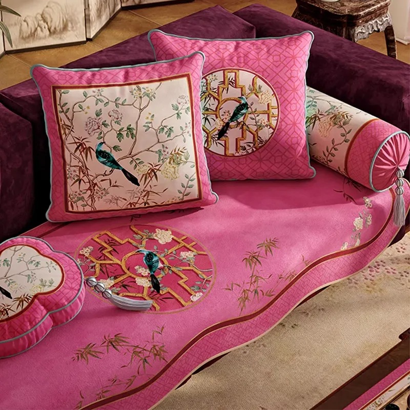 Square and cream chinoiserie pillows on sofa, overhead view.