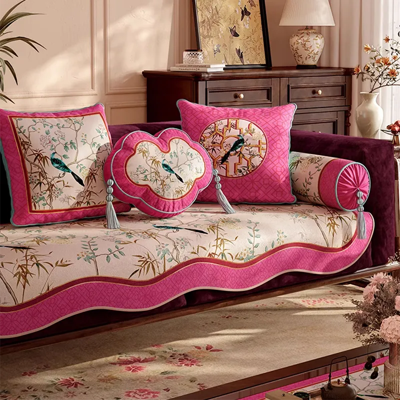 Square, ruyi and armrest chinoiserie pillows on sofa, angled view.