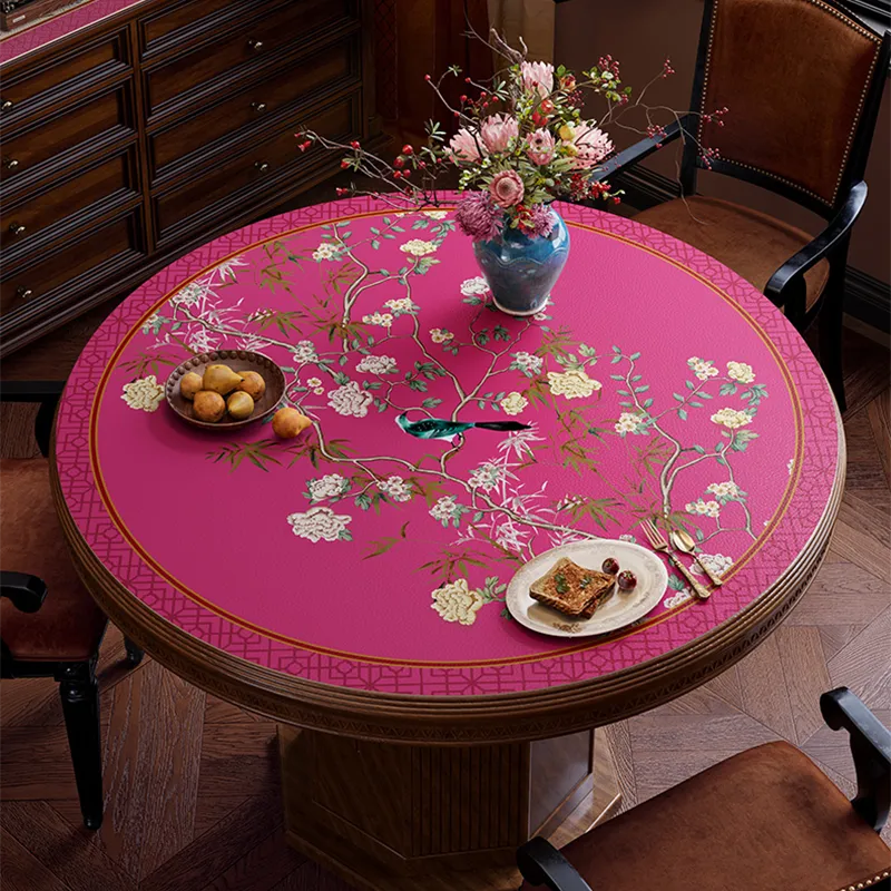 Pink chinoiserie floral bird table mat on round table, top view.