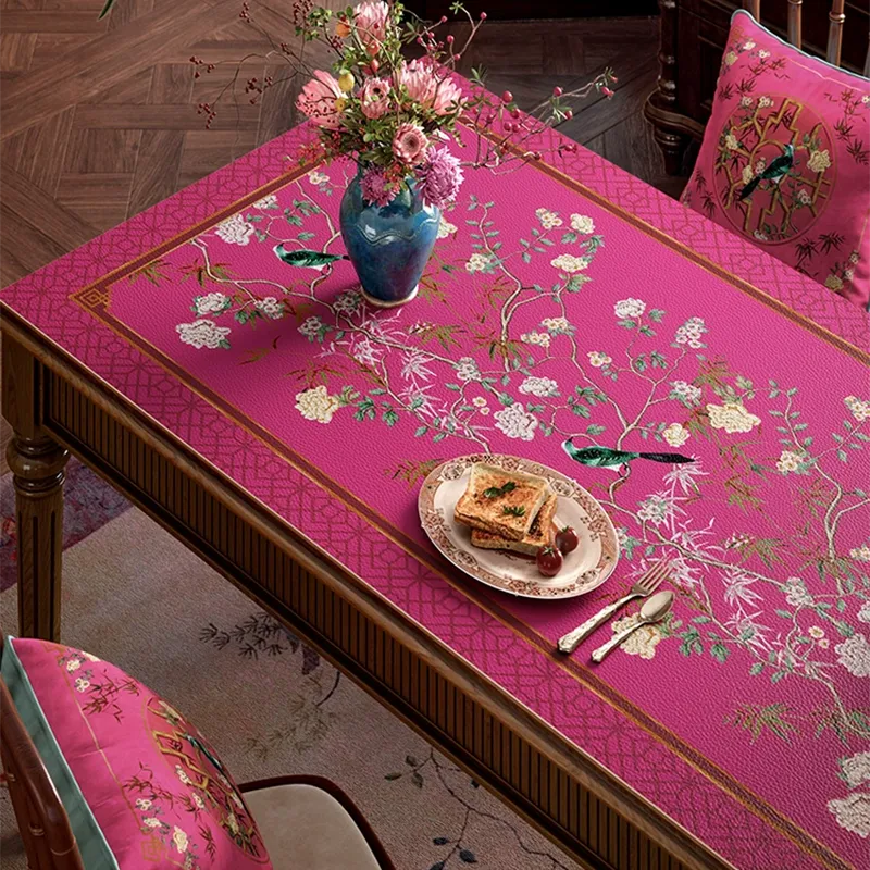 Left detail of pink chinoiserie leather table mat.