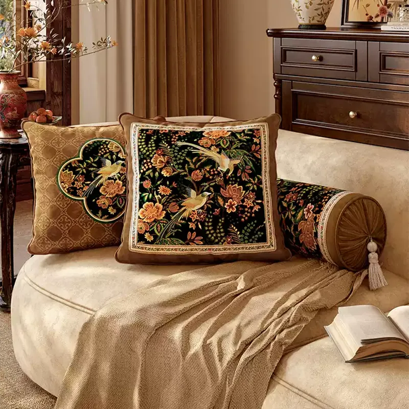 Luxury chinoiserie magpie pillows on sofa, distant angled view.