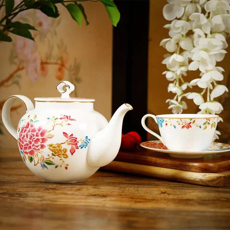 Chinoiserie tea service arranged on rustic wooden table.