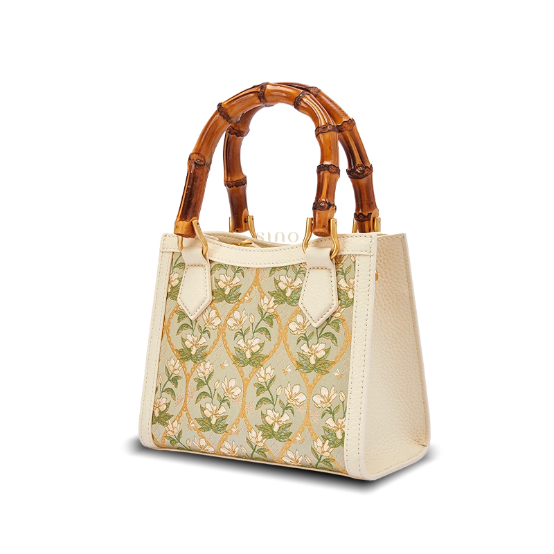Front view of Dayun Brocade handbag featuring elegant green floral patterns woven into traditional Chinese silk textile.
