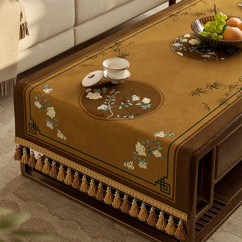 Decorative fringe trim on brown tablecloth.