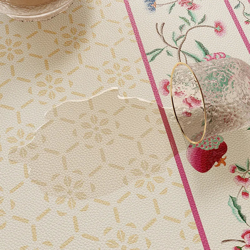 Waterproof coral pink round leather table mat with easy-clean surface.