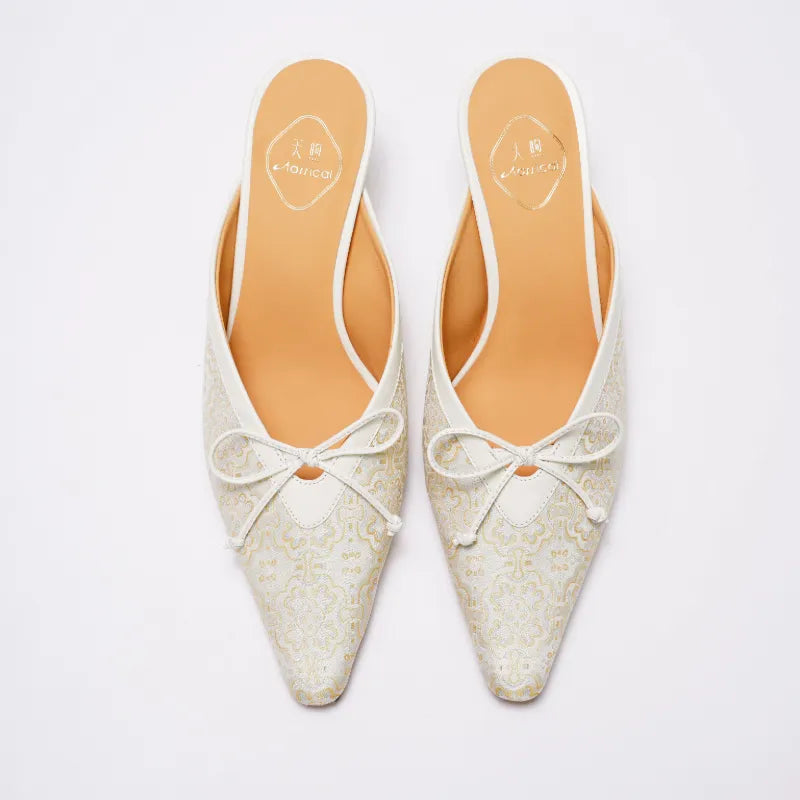 White Ding Sheng pattern mule heels side profile showing the graceful kitten heel silhouette.