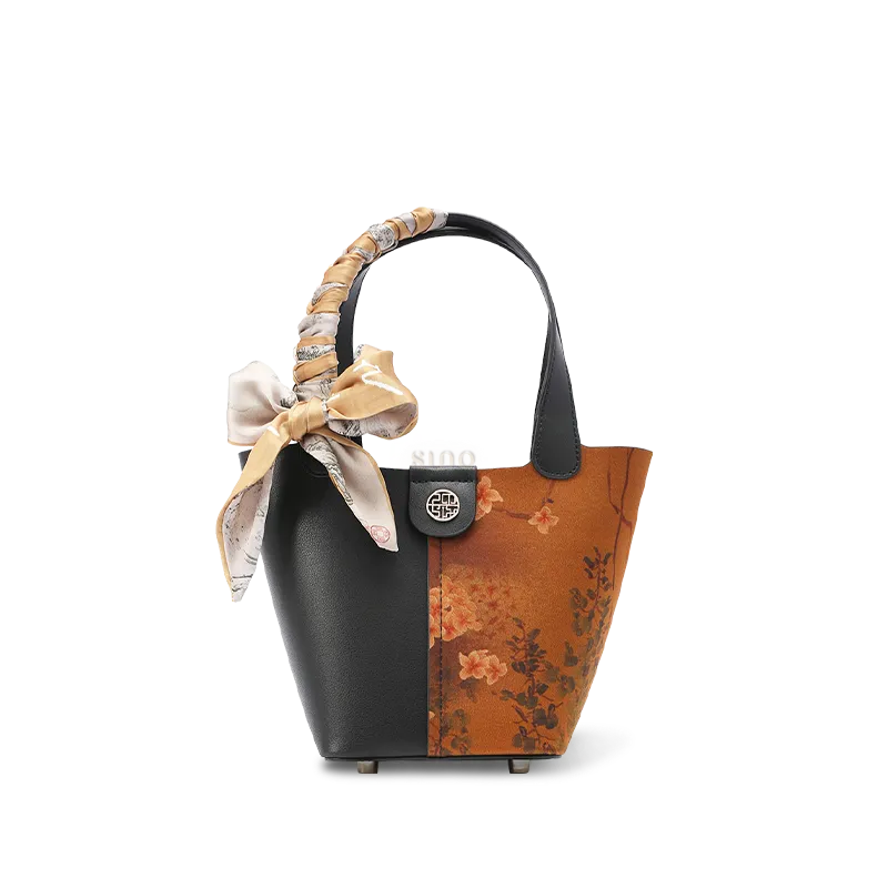 Front view: Xiangyunsha silk handbag with plum blossom embroidery.