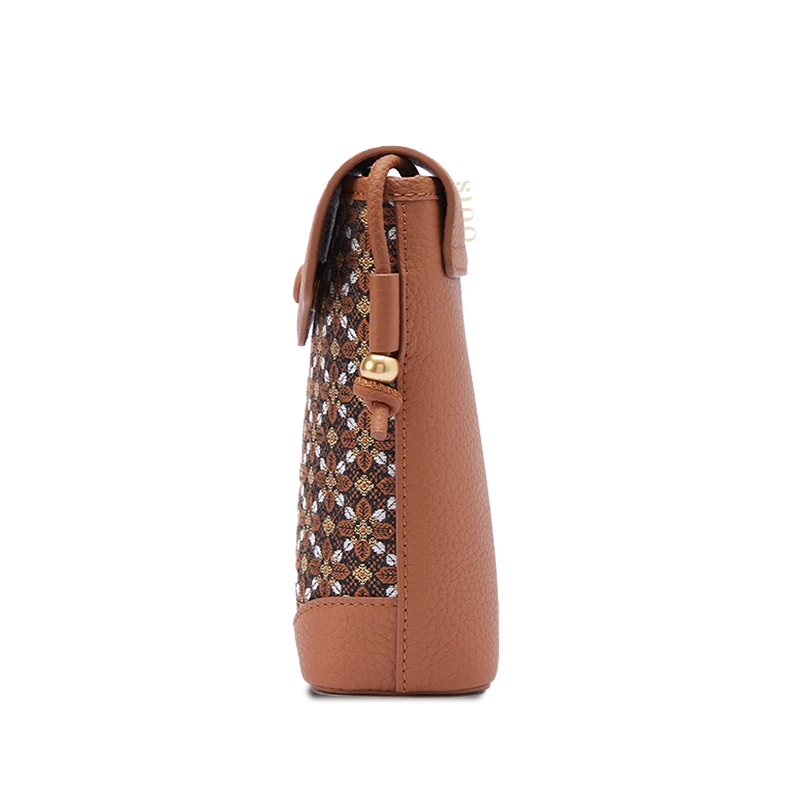 Brown cell phone crossbody bag side view showing its slim profile, cowhide leather construction, and compact silhouette.