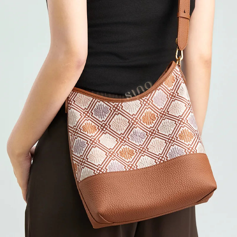 Back view of a model wearing the brown Chrysanthemum Meander Zhuang Brocade leather shoulder bag.