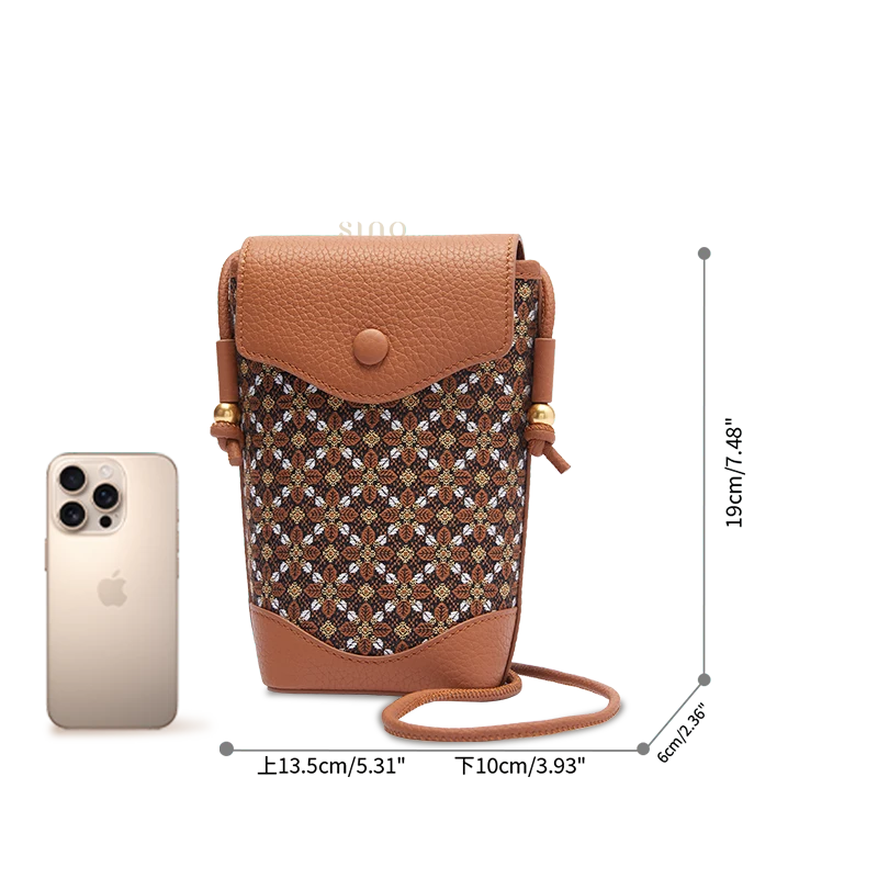 Zhuang Brocade crossbody phone bag size reference showing the compact brown phone purse beside a smartphone.