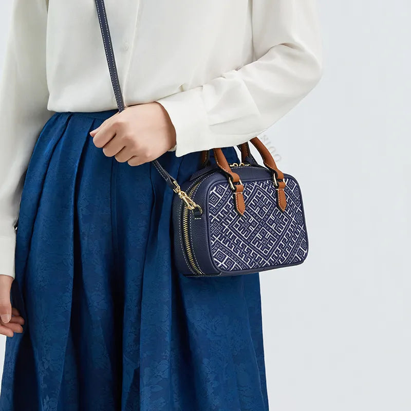 Model wearing Boston bag crossbody style at hip.