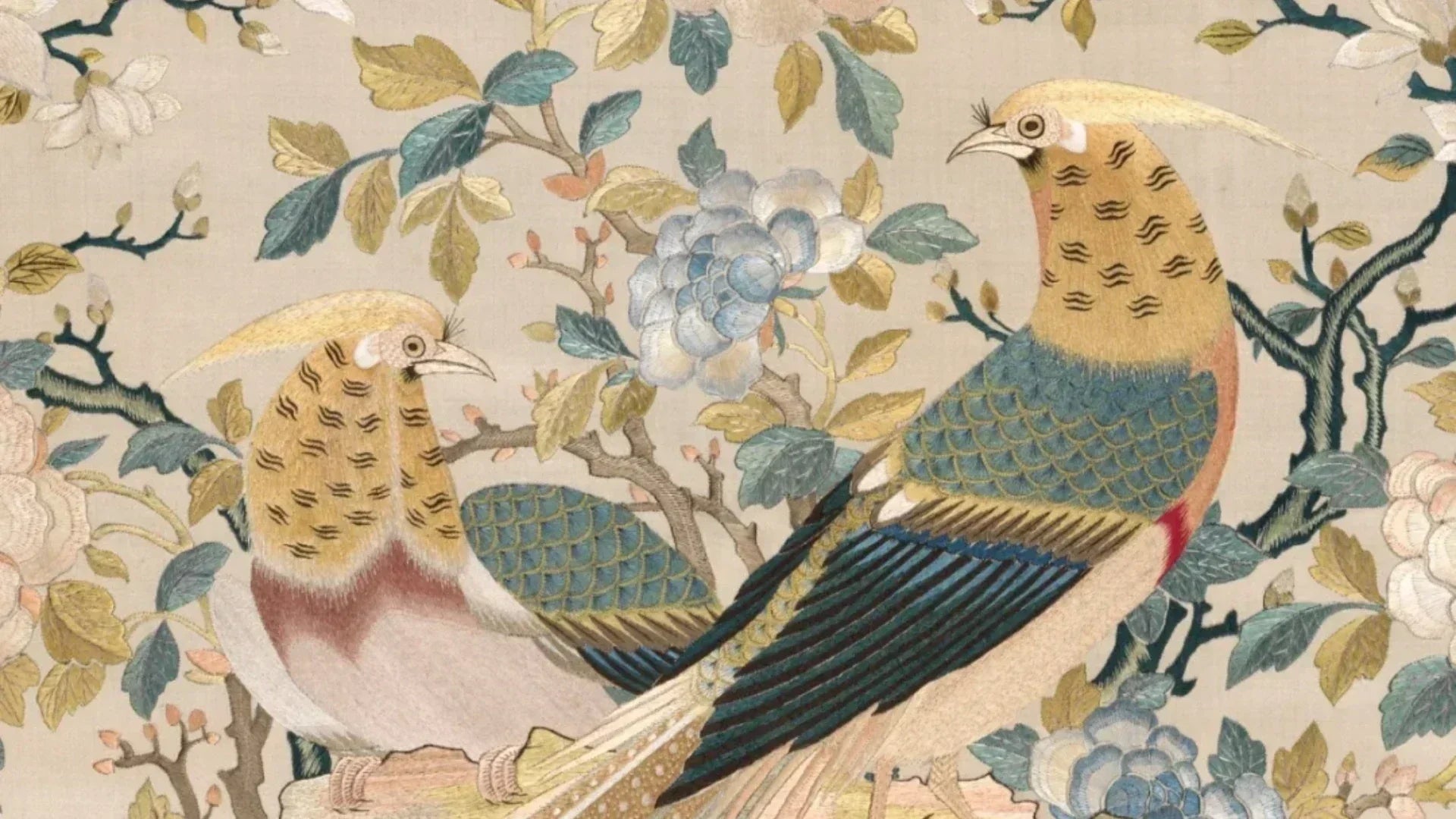 Intricate Cantonese embroidery of two birds (golden crests, teal scaled feathers) perched among blue peonies—capturing the elegance that inspires our porcelain dinnerware.