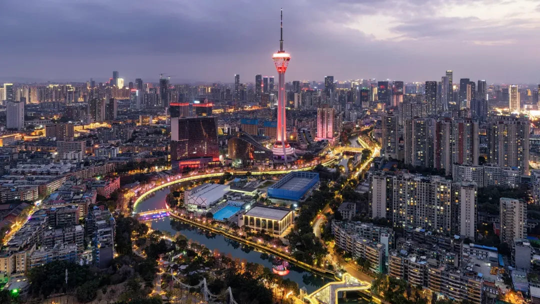 Chengdu nightscape with red TV tower, illuminated skyline, and river for 2026 travel guide on culture, food, and Shu Brocade