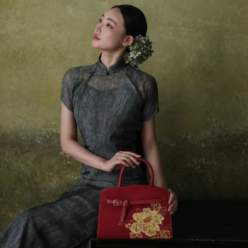 Chinese embroidered purse featuring a red magnolia leather handbag for elegant cultural styling.