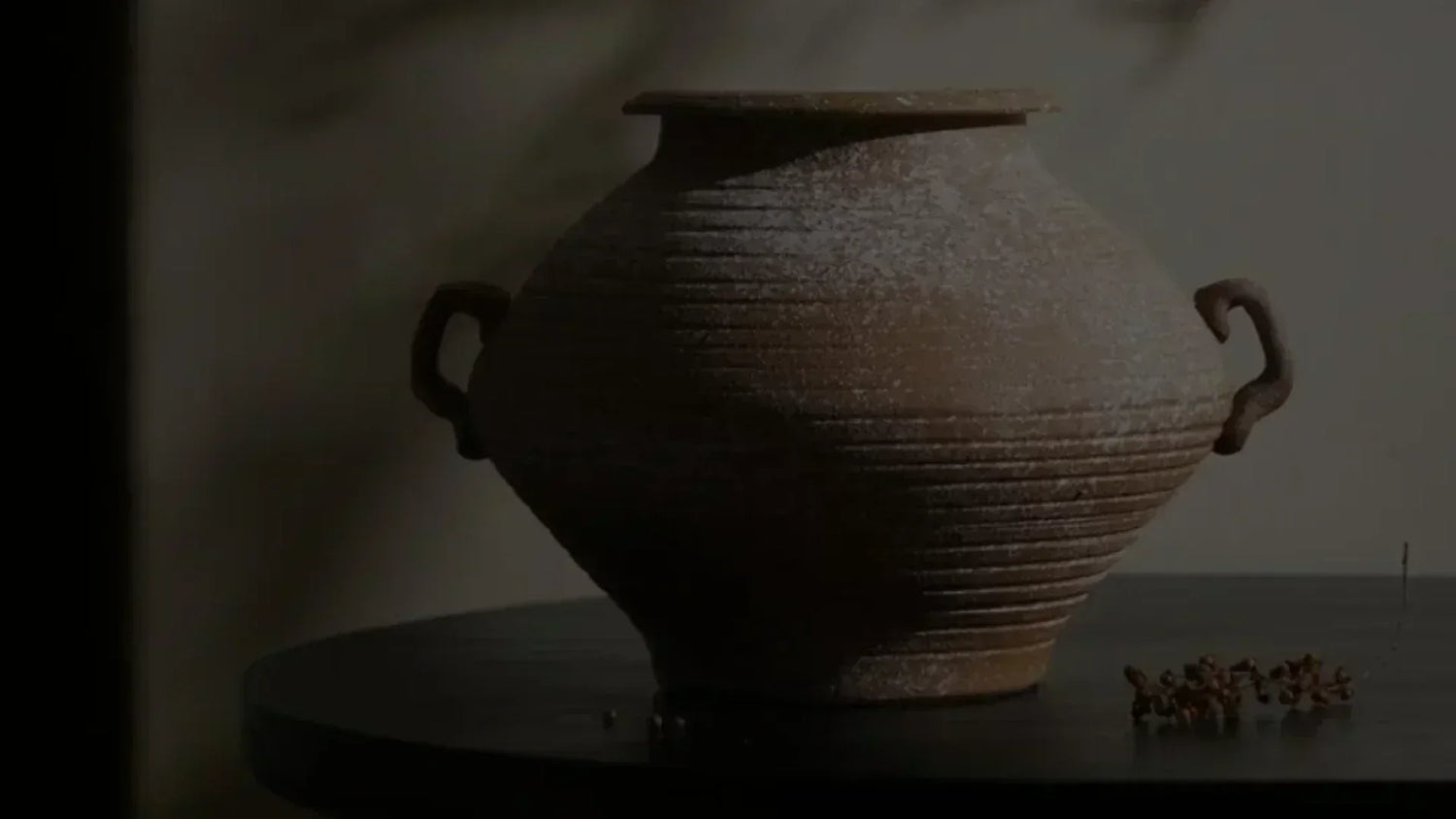 Ancient-style brown clay pot with textured ridges and handle—roots of China’s porcelain journey.