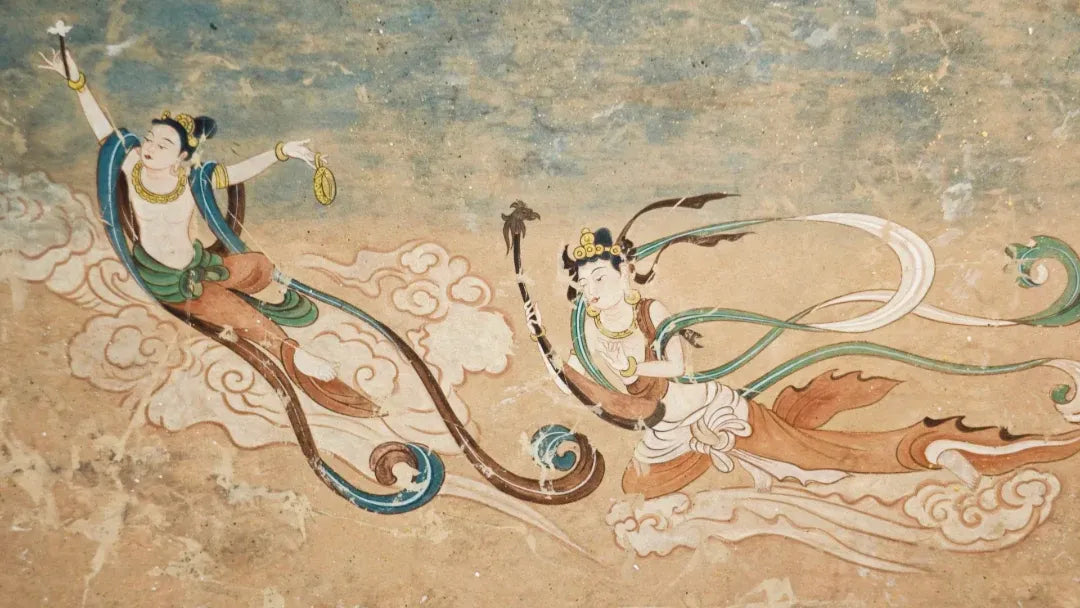 Dunhuang mural featuring flying apsaras with flowing silk scarves and cloud motifs, a iconic Silk Road cultural symbol.