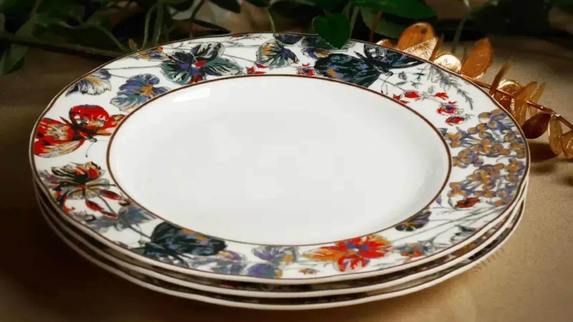 Stacked lace-trimmed Chinoiserie luxury bone china plates with golden butterfly and vibrant floral patterns from the "Golden Butterfly Waltz" collection.