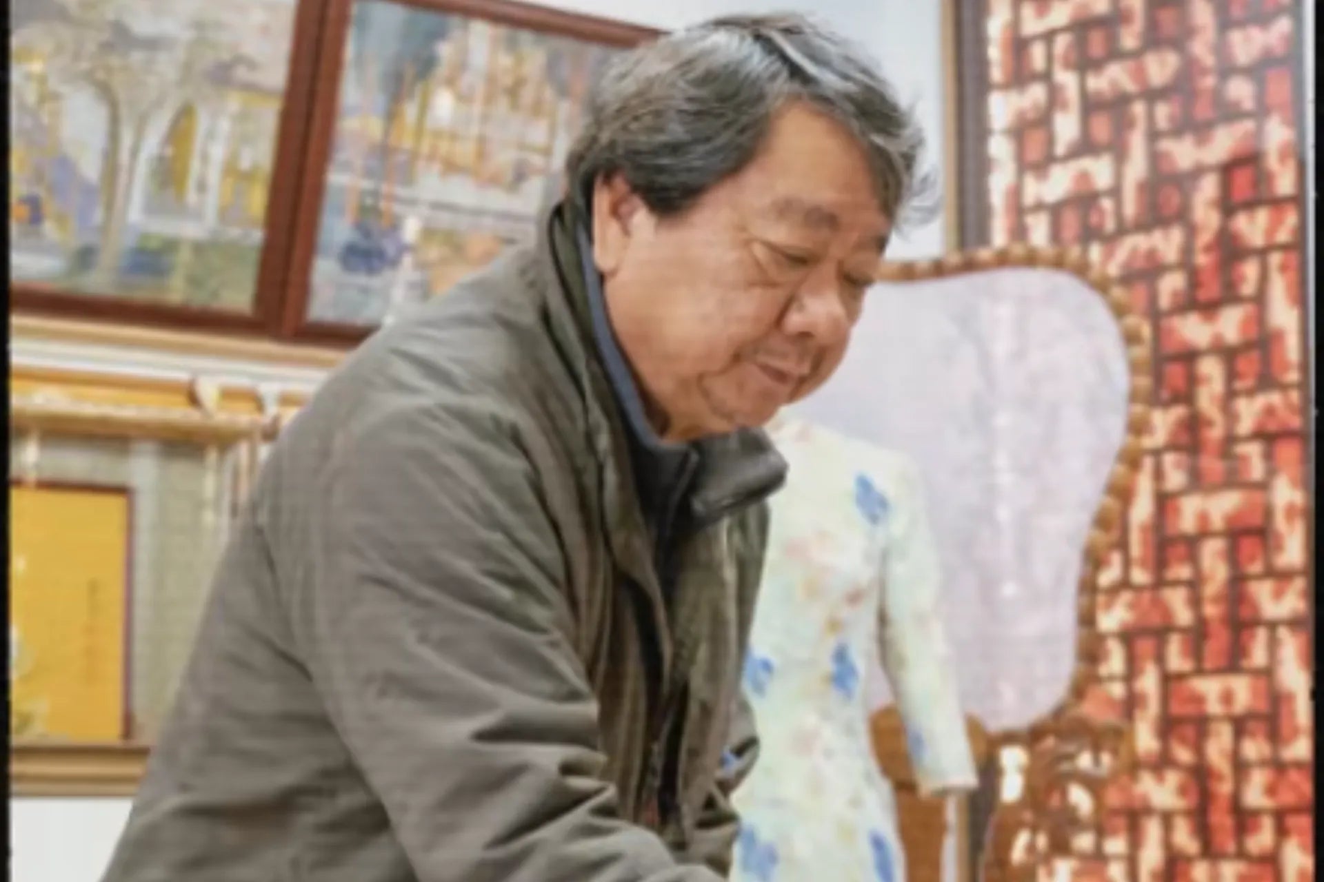 Chinese master weaver Li Dexi working on traditional Suzhou Song Brocade in his silk weaving studio.