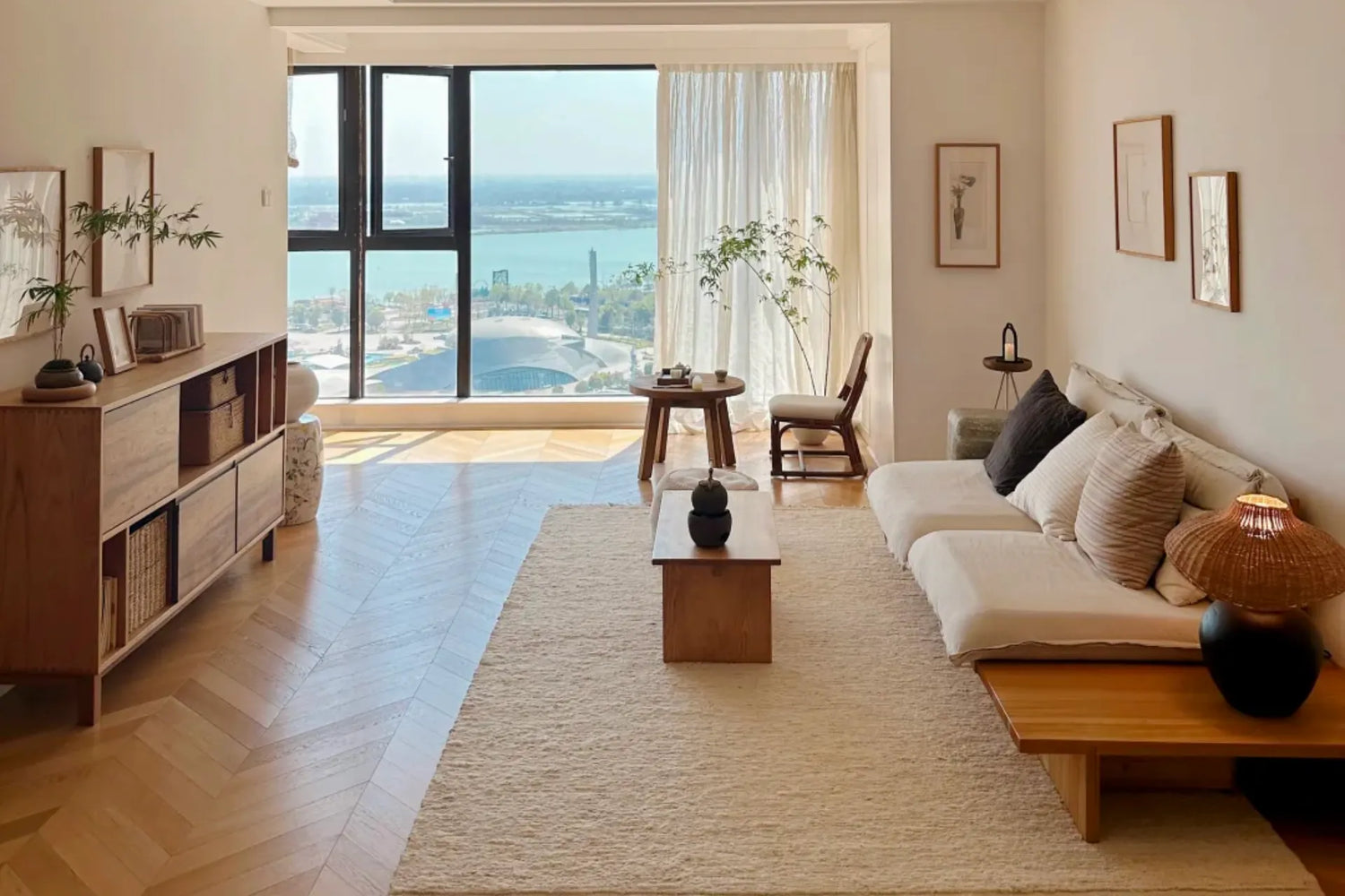 Bright and airy living room with natural light, neutral decor, light wood furniture, and soft summer home accents for a 2026 summer home refresh.