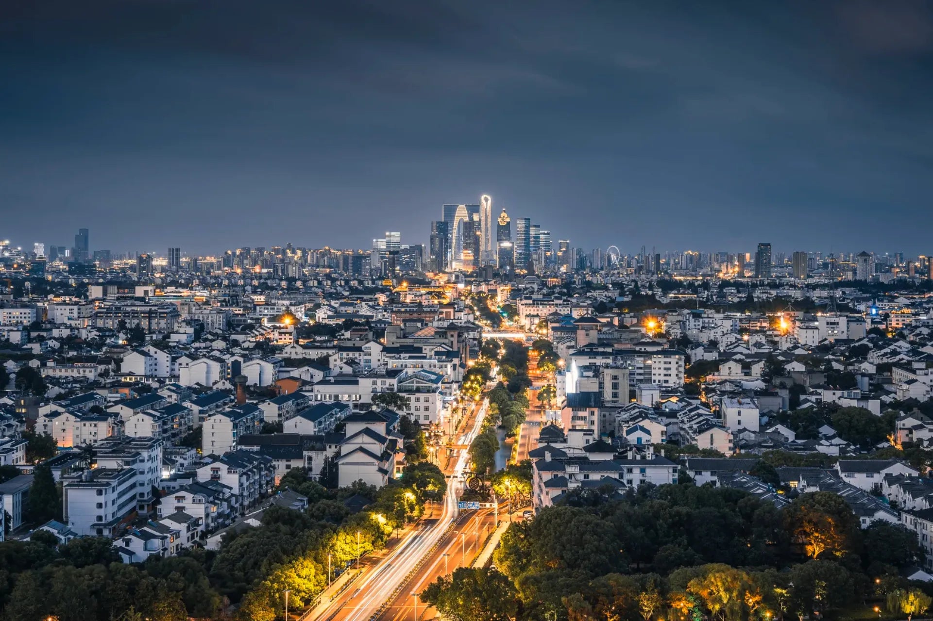 Panoramic view of Suzhou old town and modern skyline at night.