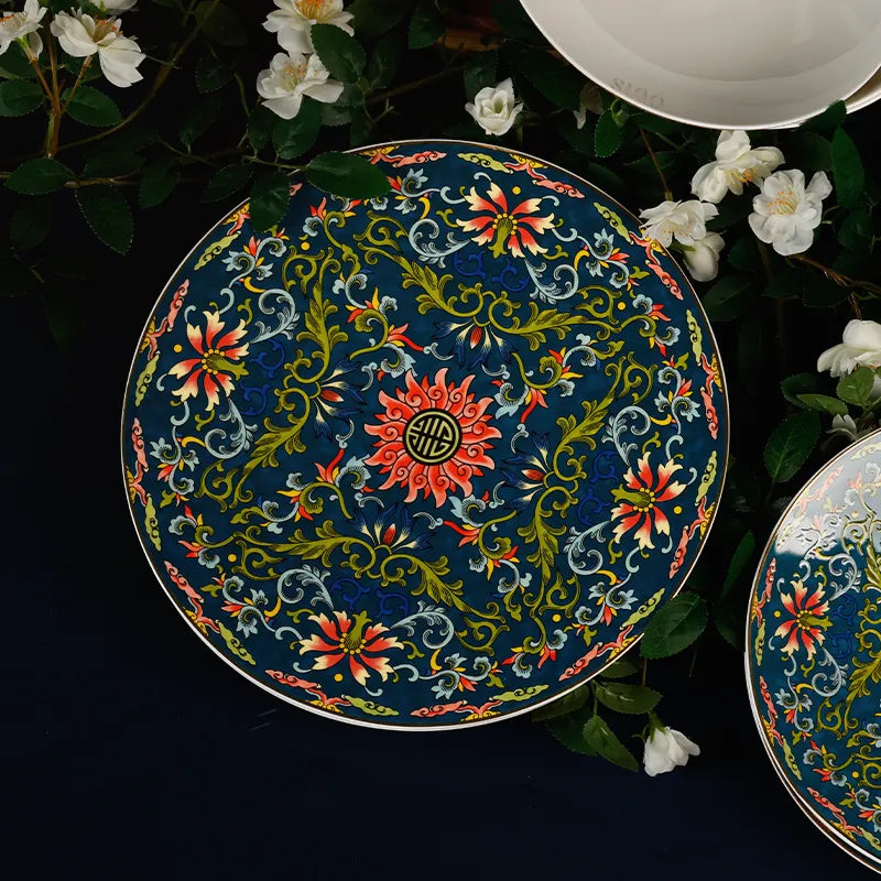 11’’ Chinoiserie Luxury Enamel Dinner Plate on blue tablecloth with white flowers (top view).