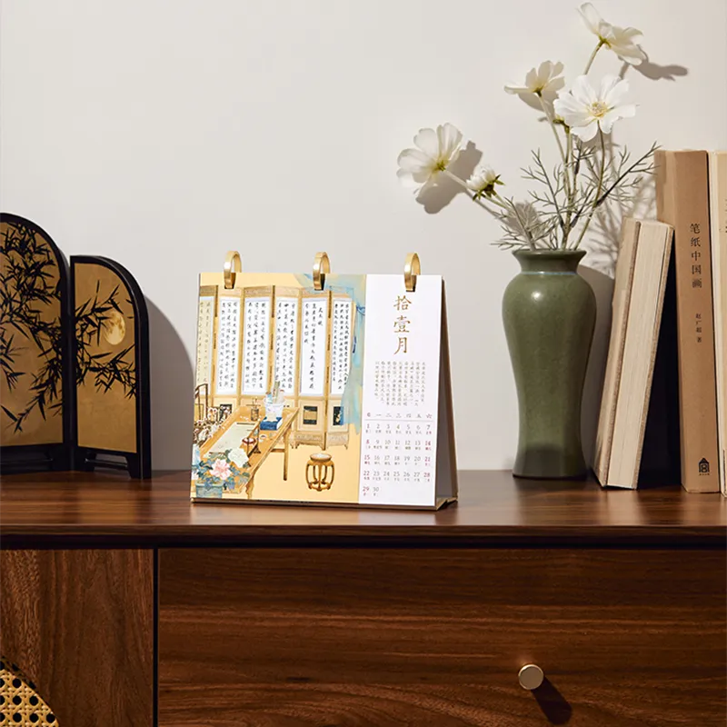 Desk calendar displayed on a table, adding festive decor to workspace.
