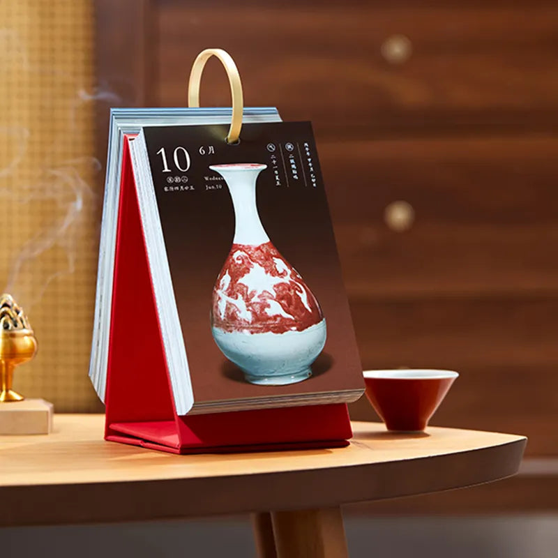 2026 Chinese Fire Horse Year New Year Calendar Set with a teacup as decoration on a table, blending tradition and daily life.