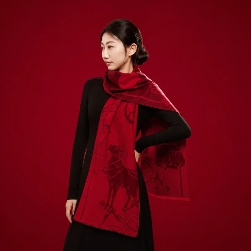 Woman styling a red Year of the Goat silk scarf as a long neck wrap, showcasing its traditional jacquard-inspired motifs.