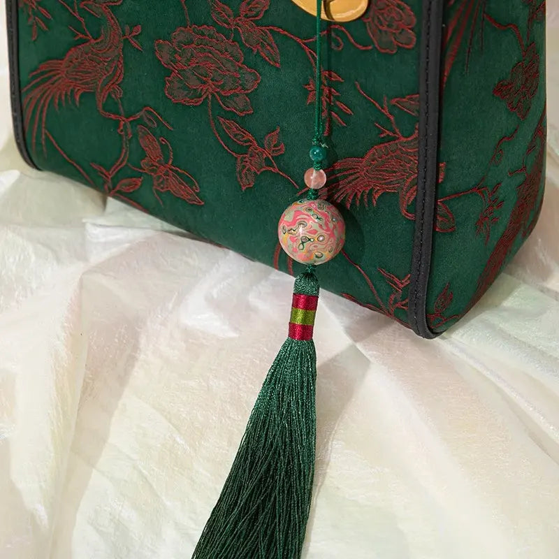 Xiangyunsha Silk Green Retro Cowhide Handbag with Pendant - SinoCultural