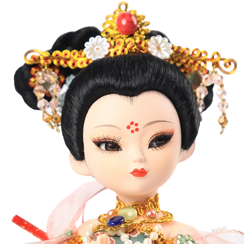 Closeup of 9-inch Dunhuang doll's hand-painted face with red beauty mark and soft, expressive eyes.