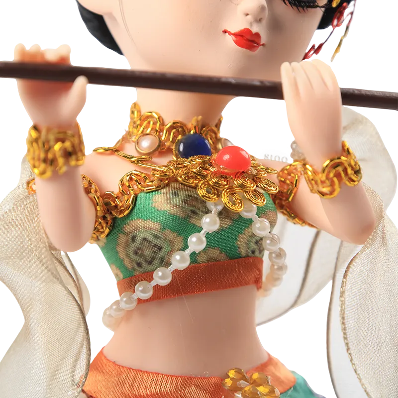 Body outfit detail of 9-inch Dunhuang "Flute Song" doll with green and orange layers.