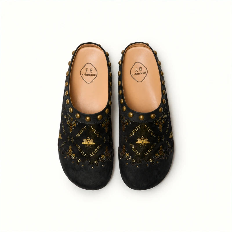 Top view of black Shu Brocade mules showcasing the gilded butterfly pattern, rounded closed toe, and traditional Chinese textile craftsmanship.
