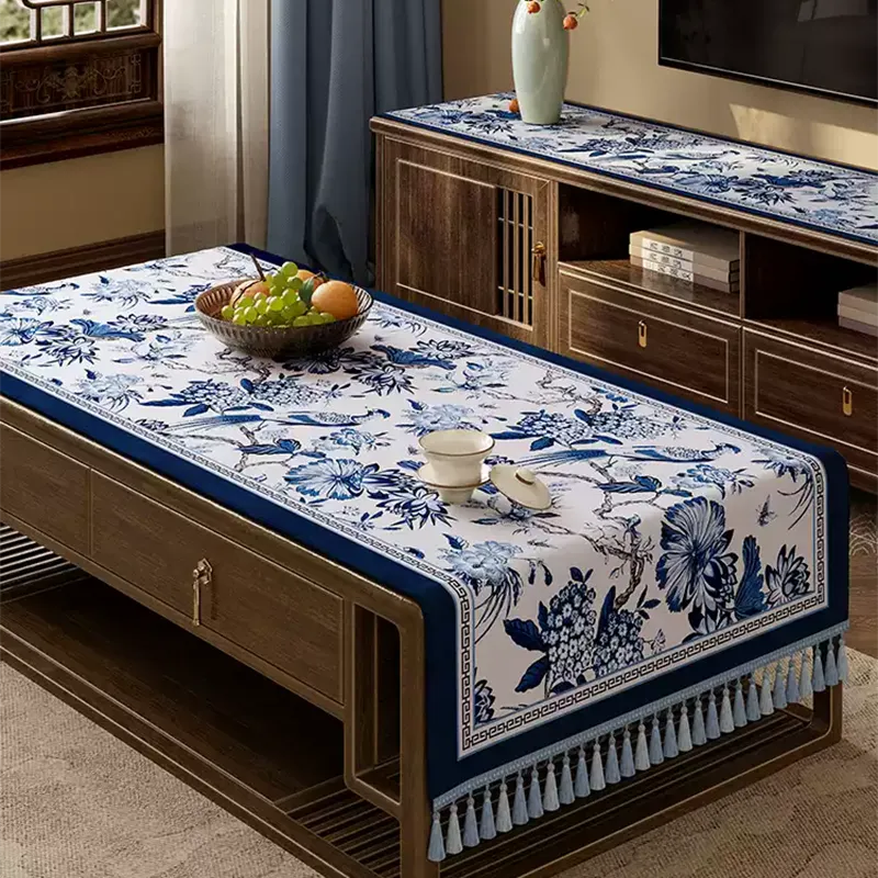 Diagonal drape of porcelain-inspired tablecloth on coffee table.