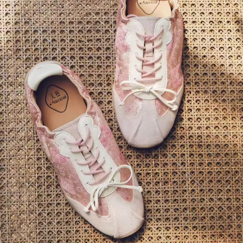 Blush Lotus Pink Shu Brocade ballet sneakers with delicate woven motifs and feminine lace-up details.