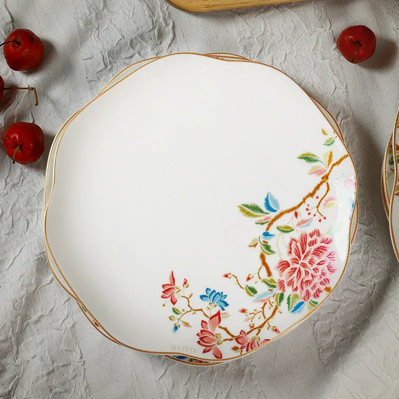 Overhead view of four stacked square dinner plates showing floral pattern alignment.