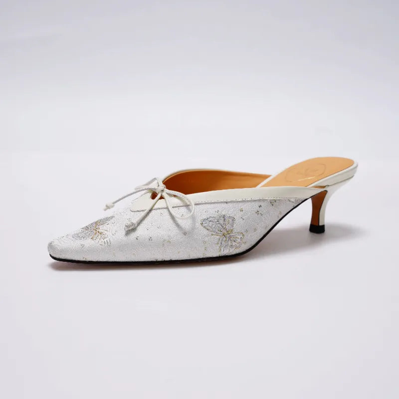 Profile view of Butterfly Reverie Song Brocade mules featuring a pointed toe silhouette, kitten heel, and handcrafted details.