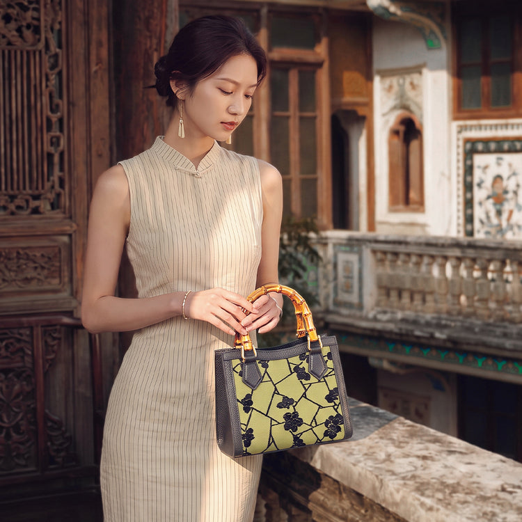 Chinese bamboo handle bag with Chinoiserie floral design, styled with an elegant traditional-inspired women's dress.