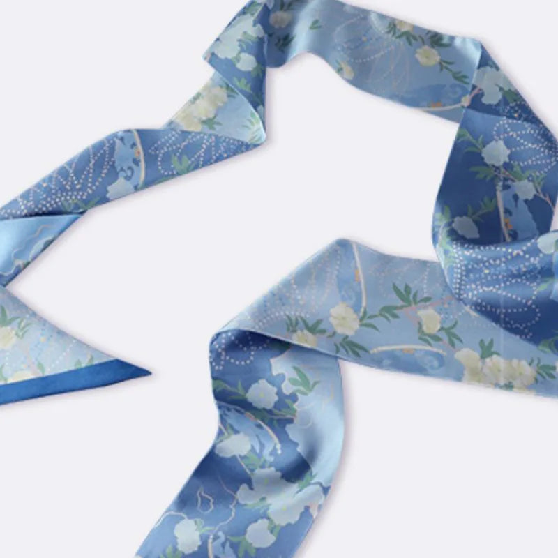 Blue Chinese Blooming Peony Mulberry Silk Twilly displayed in a flowing arrangement with delicate peony-inspired floral patterns.