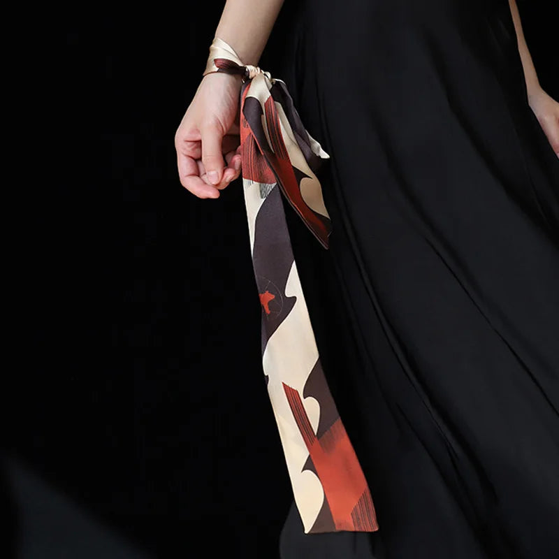 Chinese Han Dynasty Painted Pottery Motif mulberry silk twilly scarf styled as a wrist accessory.