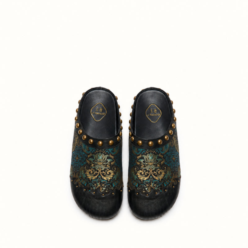 Detailed view of Chinese-inspired black mule shoes with brocade fabric and gold accents.