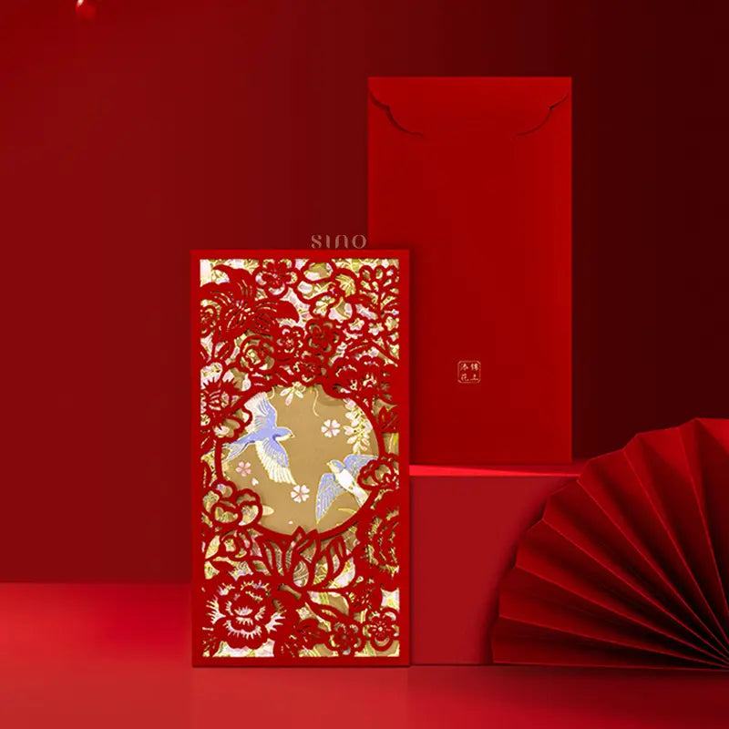 Elegant Chinese red envelope featuring an intricate red floral cutout frame, two decorative birds, and a gold-toned background, displayed with its matching red envelope back.
