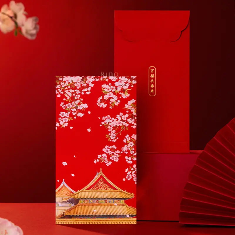 Traditional Chinese red envelope featuring pink spring blossoms and a golden palace roof, displayed beside its red reverse side with gold Chinese blessing text.
