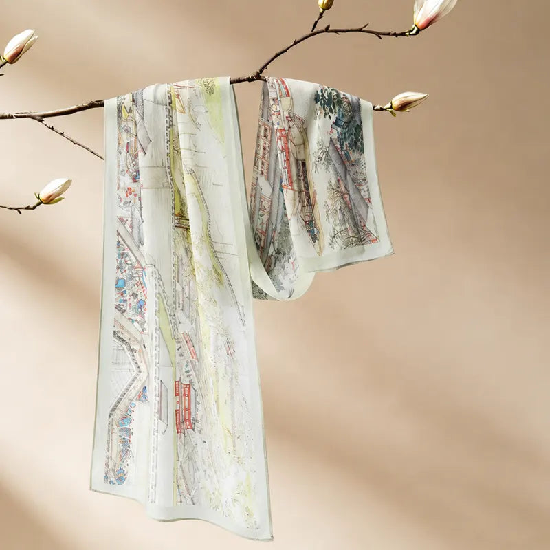 Chinese Prosperous Suzhou Print Mulberry Silk Long Scarf displayed on a flowering branch with detailed Suzhou landscape artwork.