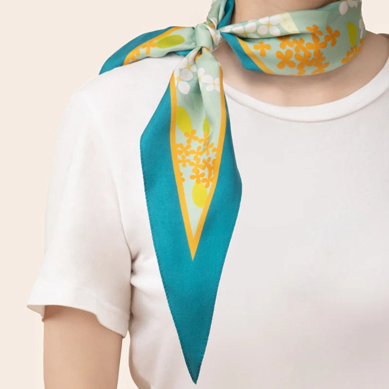 Model wearing the Chinese Verdant Garden Print Mulberry Silk Diamond Scarf 120x32 cm tied around the neck.
