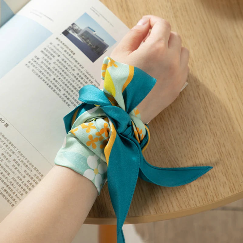 Chinese Verdant Garden Print Mulberry Silk Diamond Scarf 120x32 cm styled as a wrist scarf with a fresh botanical print.