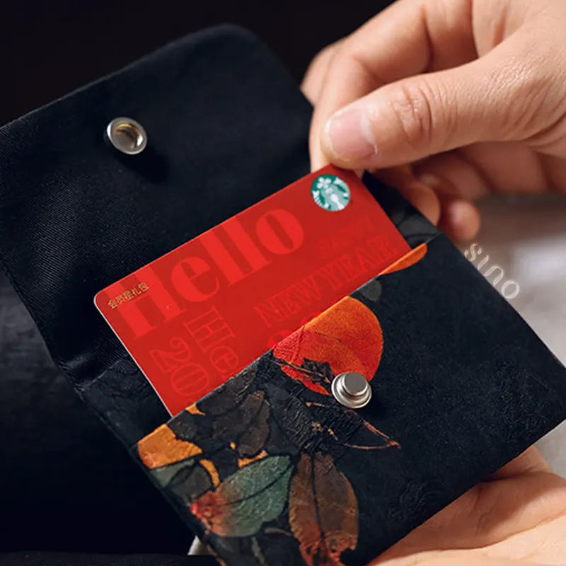 Open view of the Chinese Xiangyunsha Silk Auspicious Persimmon Snap Wallet with a card inside, showing its practical two-layer storage and fabric lining.