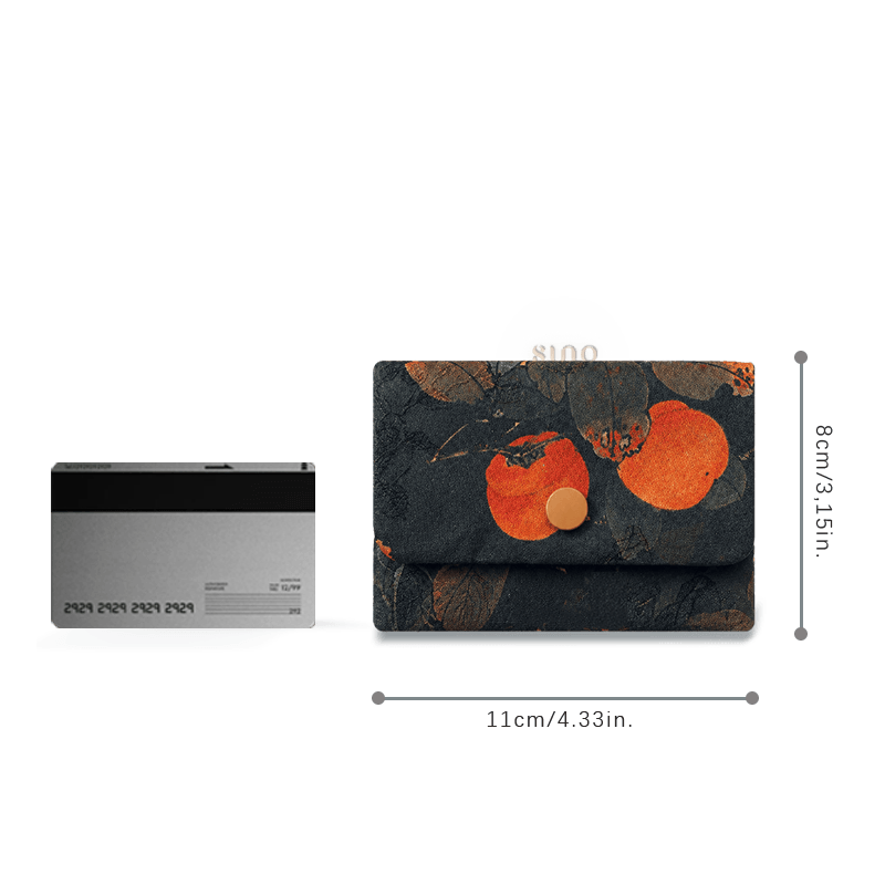 Size reference of the Chinese Xiangyunsha silk persimmon card holder wallet beside a bank card, measuring approximately 11 × 8 cm.