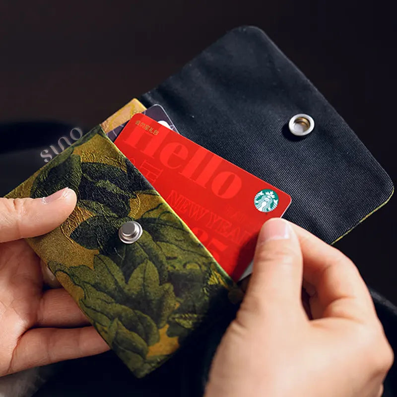 Open view of the Xiangyunsha silk snap wallet with cards inside, showing its practical two-layer storage and soft fabric lining.