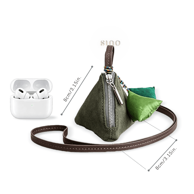 Size reference of the Chinese Xiangyunsha silk zongzi coin purse beside wireless earbuds, measuring approximately 8 × 8 cm.